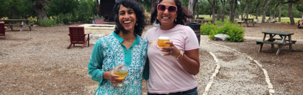 Two South Asian women pose for a photo.